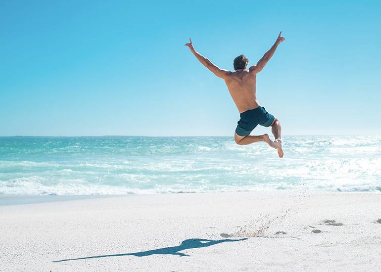 jumping for joy on beach