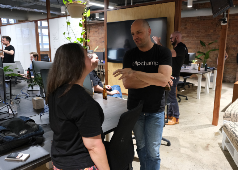 clipchamp ceo alex dreiling talking to colleague at the precinct office in brisbane