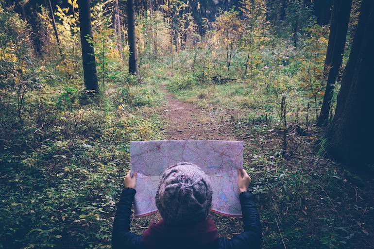 Hiker in forest lost with map