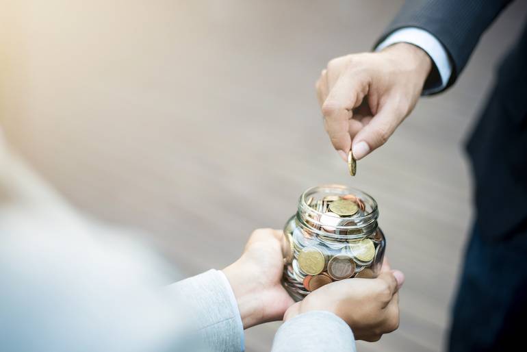 begging - coin put in a glass jar