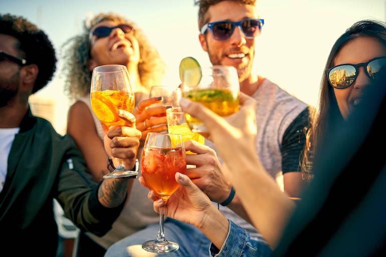 friends having drinks together outdoors.
